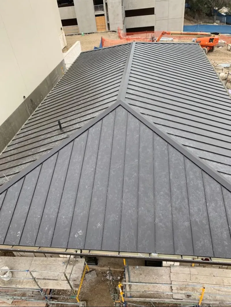 Commercial metal roof construction with crane equipment in Laughlin